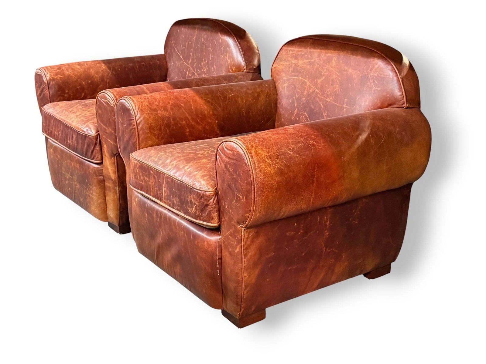 Pair of Cognac Tone Leather Chairs: Pair of Cognac colored leather lounge chairsHeight: 32 inchesWidth: 34 inchesDepth: 30.5 inchesSeat Height: 18.5 inches