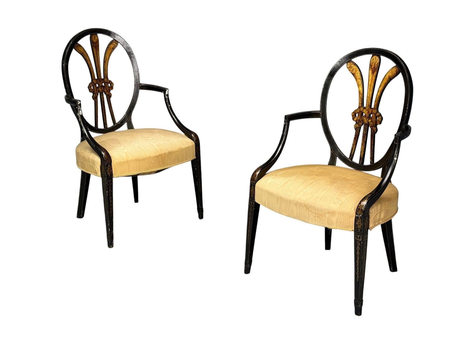 Pair of Ebony and Gilt Feather Back Armchairs: Each in the Maison Jansen Style with finely gilt feather backs. The ebony framed in need of refinishing. Pair of chairsHeight: 37.5 inchesWidth: 21.75 inchesDepth: 20 inchesSeat Height: 18 inchesFrom