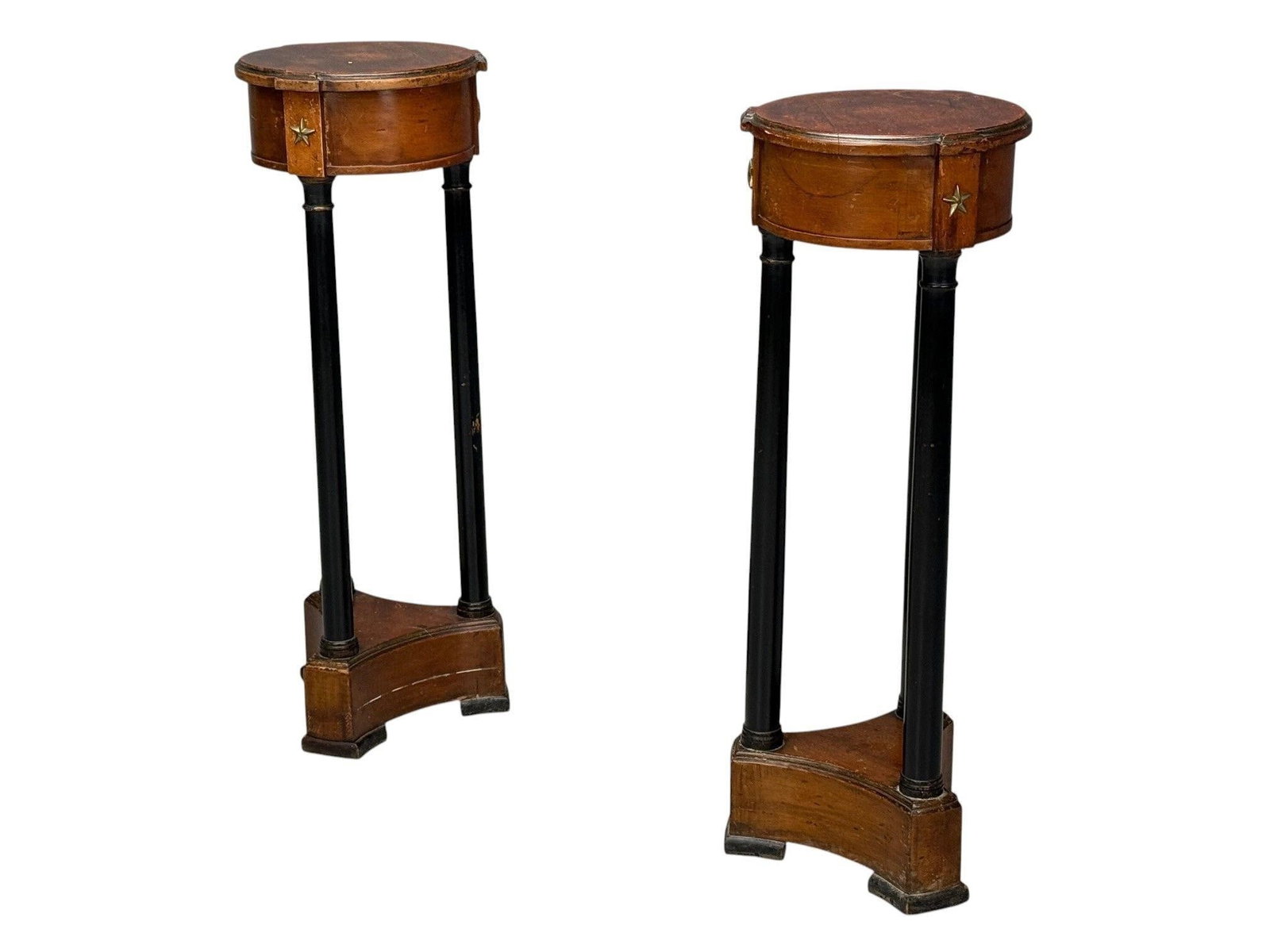 Pair of Empire Style Wooden Pedestals: Pair of wooden pedestals with carved star details, Ebony and walnutHeight: 35.75 inchesDiameter: 12.5 inchesFrom a Fresh Waterfront Rhode Island Estate