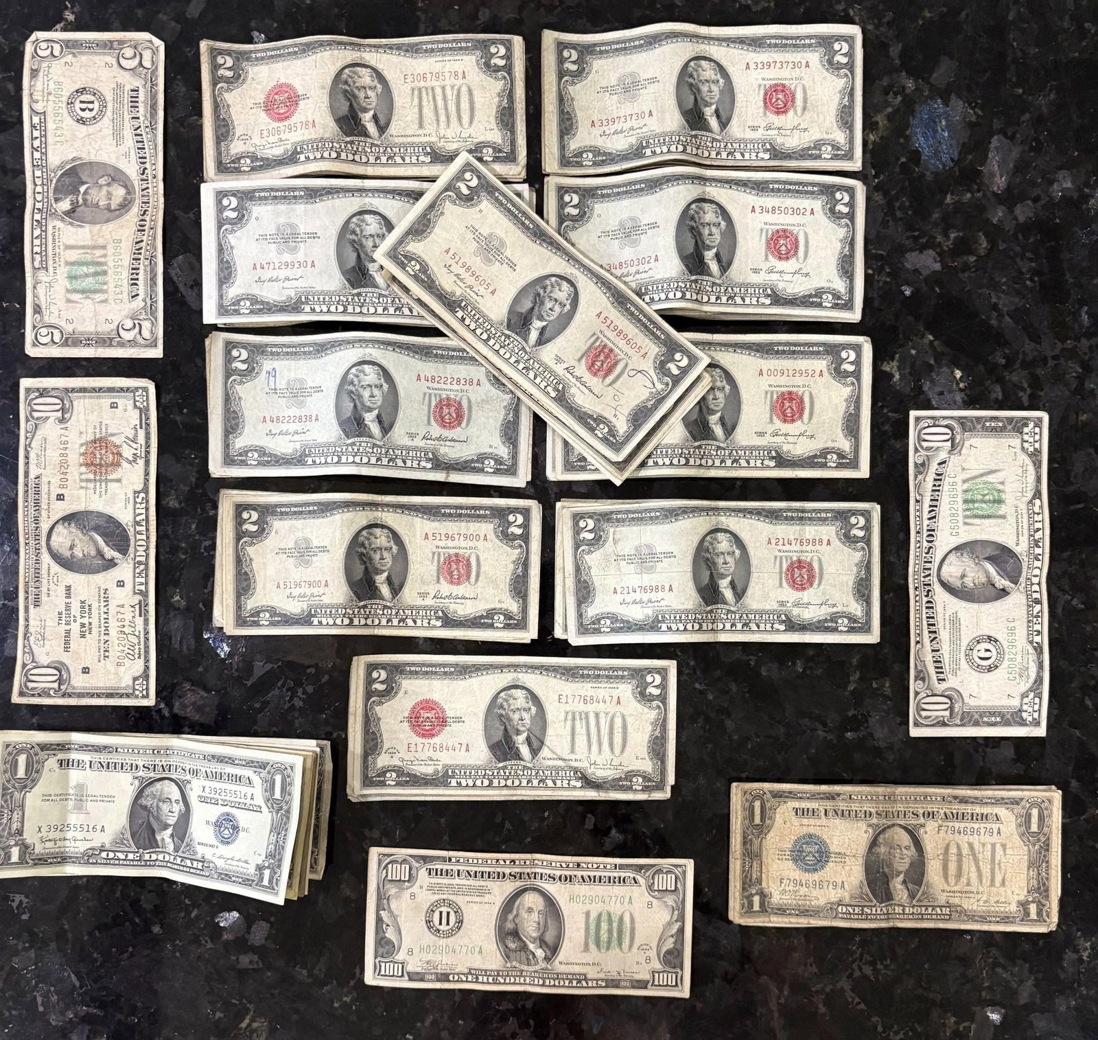 Silver Certificates, 245 Dollars Face Value: A collection of 74 US Currency Bills. 245 in face value. One One hundred dollar bill. Two ten dollar bills, One five dollar bill, Fifty red two dollar certificates and twenty blue one dollar