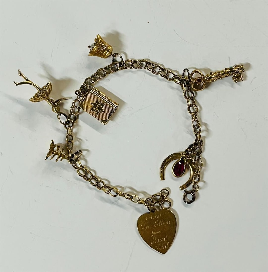 A 14k Gold Charm Bracelet Seven Charms, 13 grams: A 14k Gold Bracelet with Seven Charms. 13 grams.