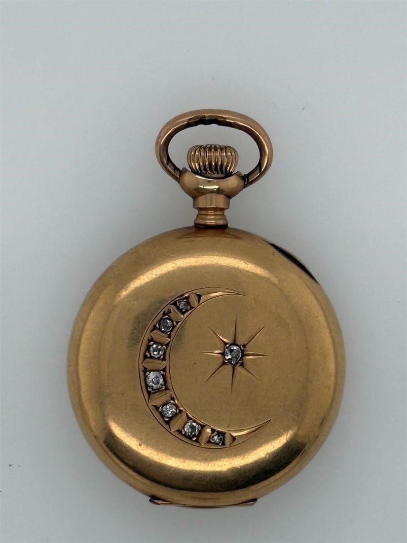 14K Waltham Pocket Watch, Hunter Case, Diamond: This is an antique Waltham pocket watch featuring a 14K yellow gold hunter case adorned with a diamond-set crescent moon and star 33.18 Grams in total 1 1/4 by 1 3/4 inches.
