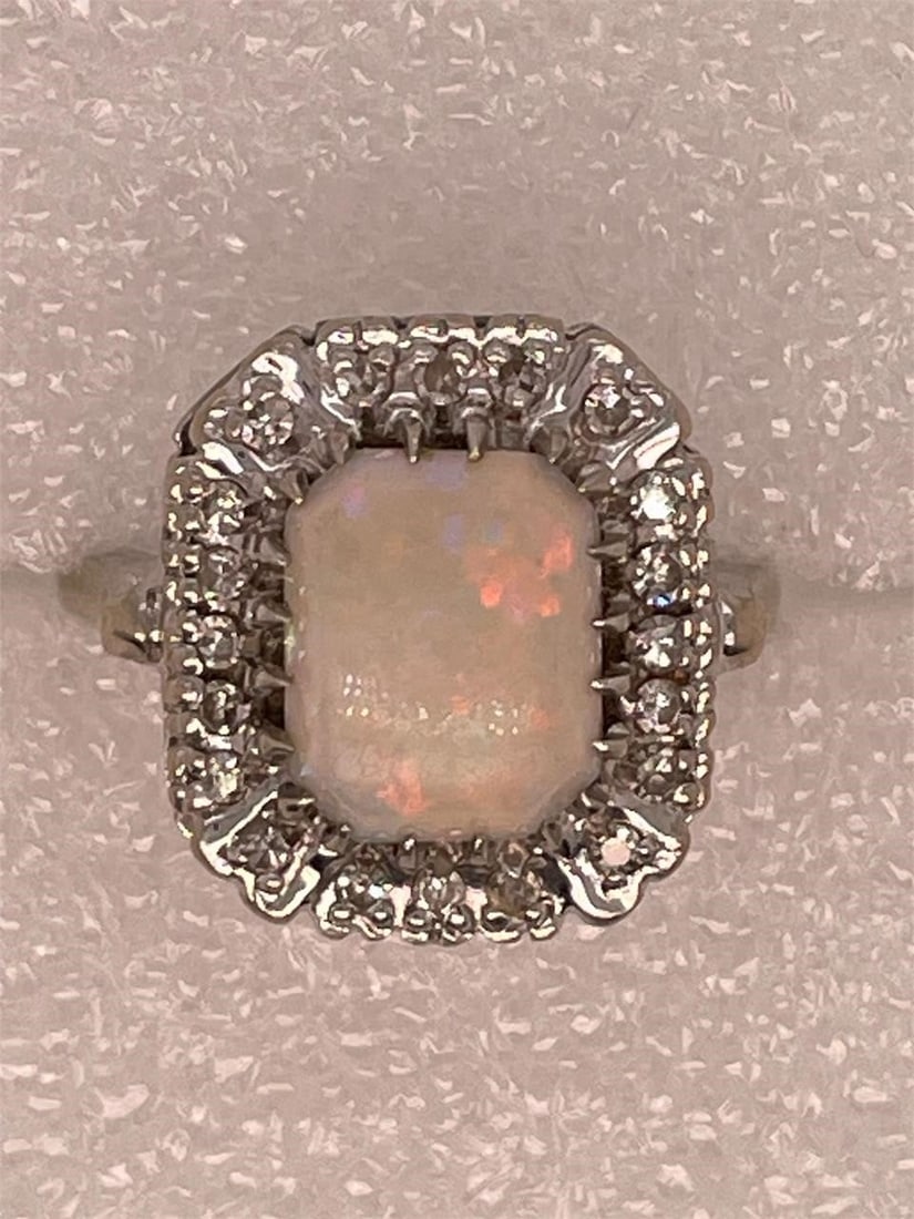 14K White Gold Opal Cocktail Ring,: A cocktail ring with a large center Opal and diamonds .Marked 14k. Size 6.75