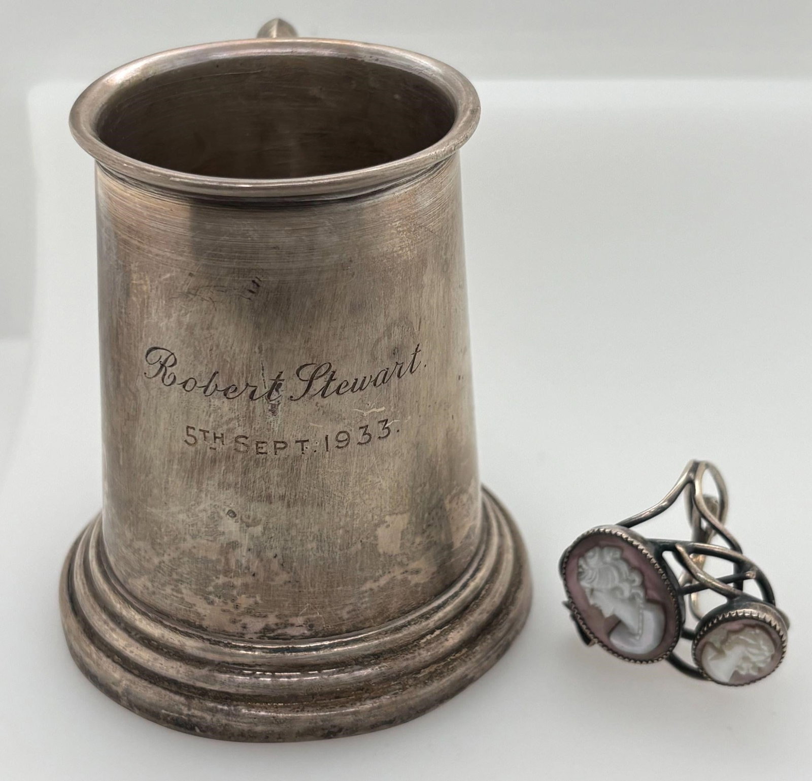 Sterling Childs Cup and Cameo Ring: A Sterling Silver Cup, Hallmarked weighing 62.63 grams 3 inches high and 2.5 inches diameter of the base. Cameo ring adjustable in size.