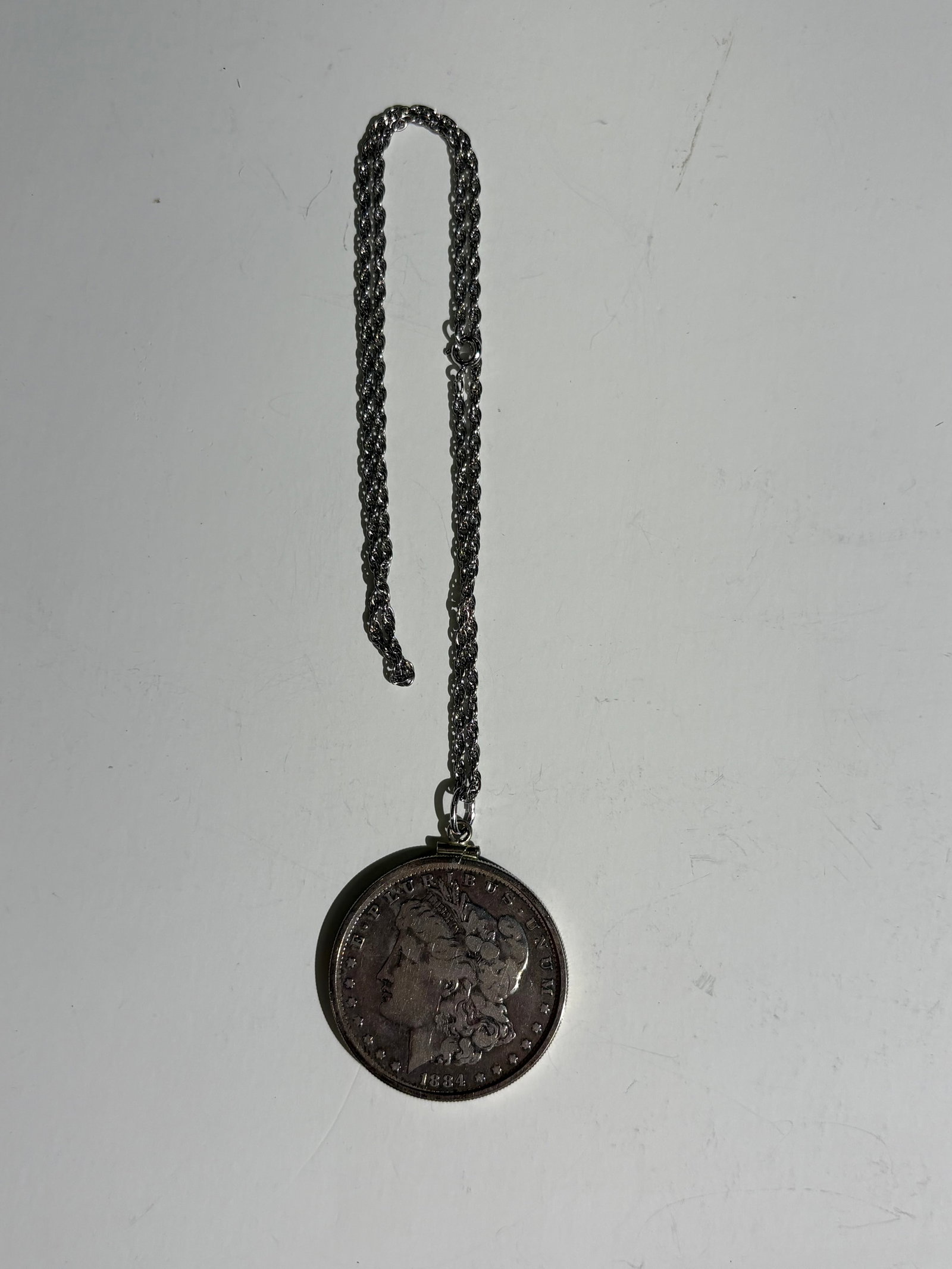 Morgan Silver Dollar Dated 1884 On a Chain: Morgan silver dollar dated 1884 on a chain