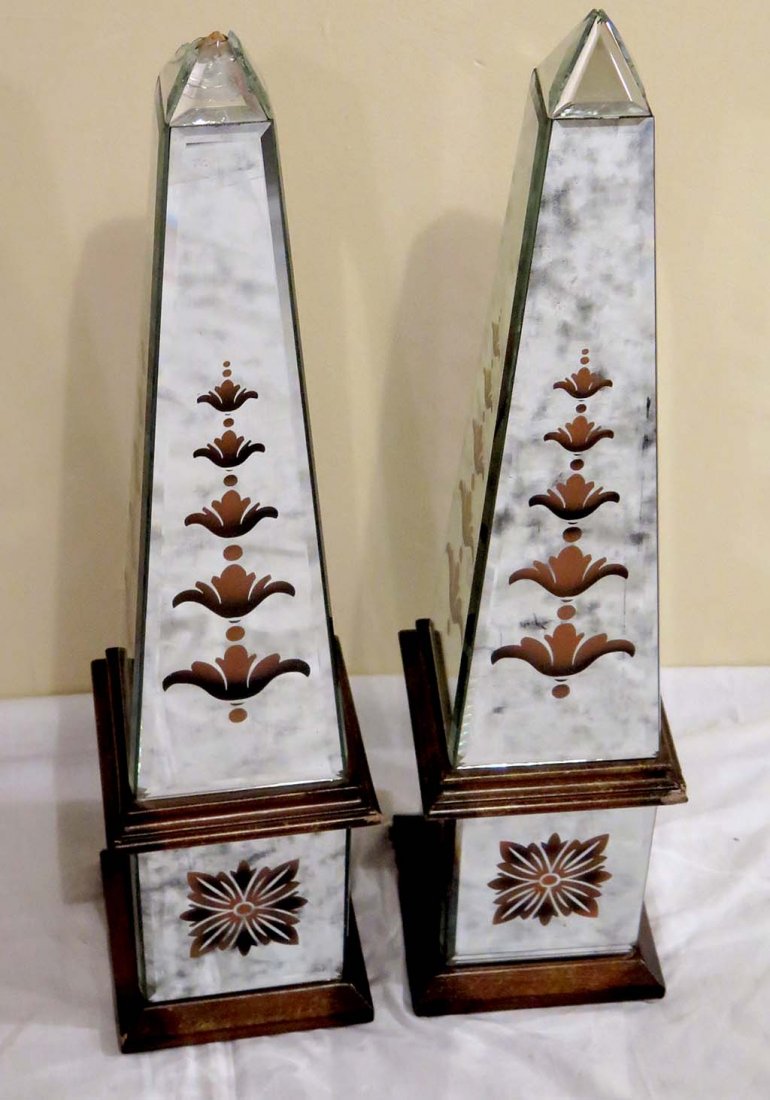 PAIR OBLISKS: A pair beveled mirrored obelisks with gilt decoration. Circa 1930's / 1940's. Note: One As Is. Measures: 5¾" L x 5¾" W x 25½" H, each.