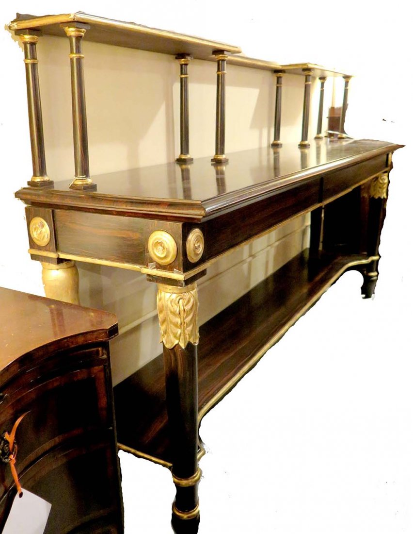 ROSEWOOD SIDEBOARD: A large Rosewood and gilt decorated sideboard having a lower curved shelf resting on cylindrical turned legs. The top shelf on eight column form supports. Measures: 92" L x 22' W x 54' H.