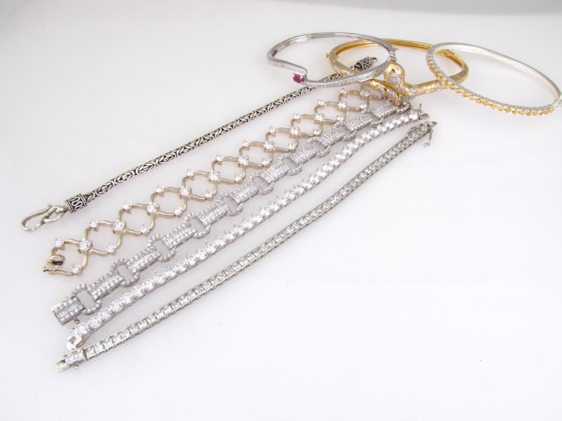 Group of Sterling Silver Fashion Bracelets: A group of eight sterling silver fashion bracelets, including three hinged bangles, three line bracelets, and two link bracelets,77.8 DWT total