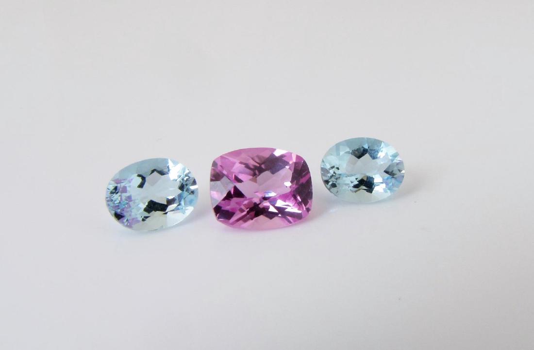 Pair of 3.1CT Aquamarine and a 3.85CT Pink Spinel: Three loose stones including a pair of oval aquamarine, 3.10ctw and a cushion cut pink spinel, 3.85ct