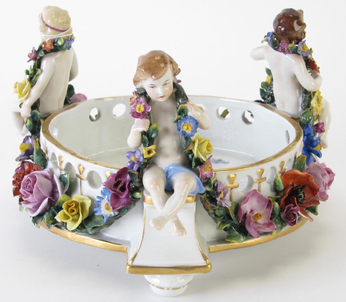 Capodimonte Figural Footed Bowl: Capodimonte Figural Footed Bowl, round bowl with three seated putti draped in flowers, floral decoration, pierced rim, hallmarked on bottom, 10" diameter and 5.5" high