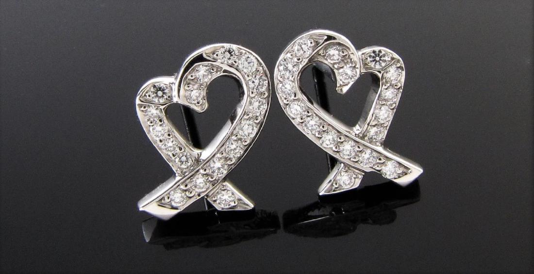 Tiffany & Co. Picasso Heart Plat/Diamond Earrings: A pair of Tiffany & Co. Paloma Picasso, Loving Heart platinum diamond earrings with thirty-four diamonds equaling approximately .35ctw