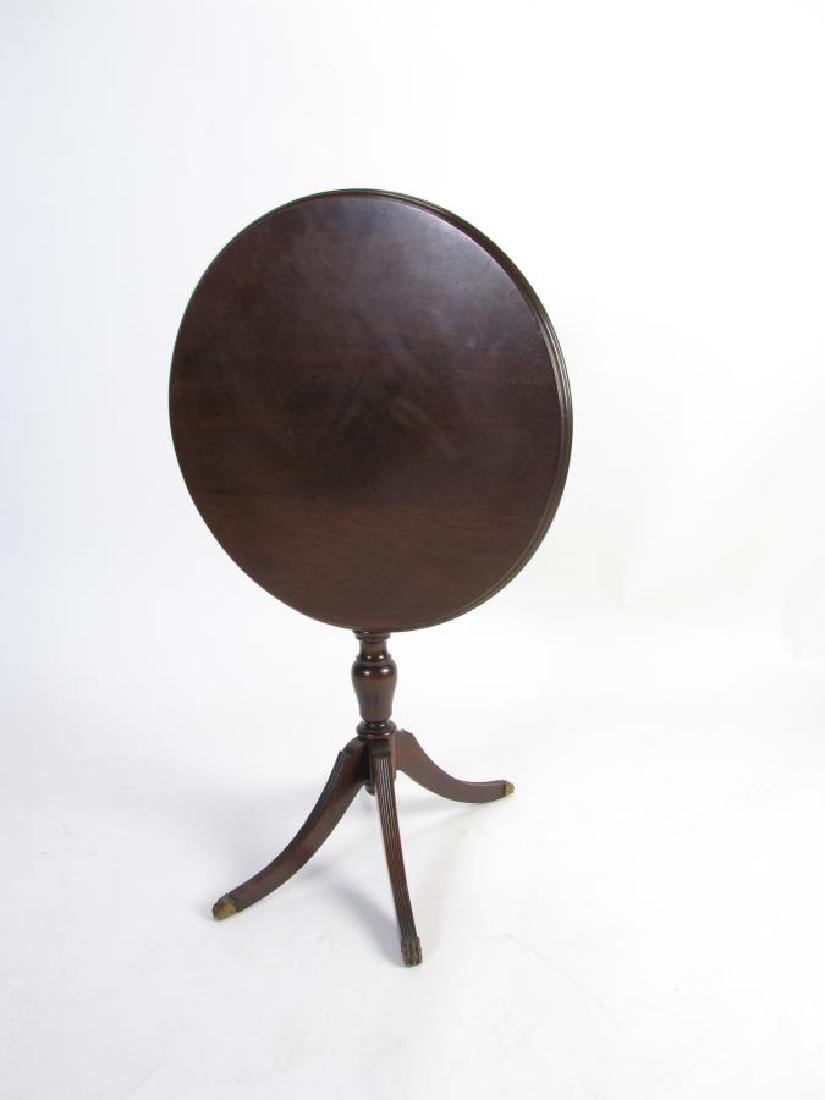 Antique Tilt-Top Table: An antique tilt-top table, mahogany, Duncan Phyfe style with four legs with brass foot caps, ca early 20th century, 26.5"h