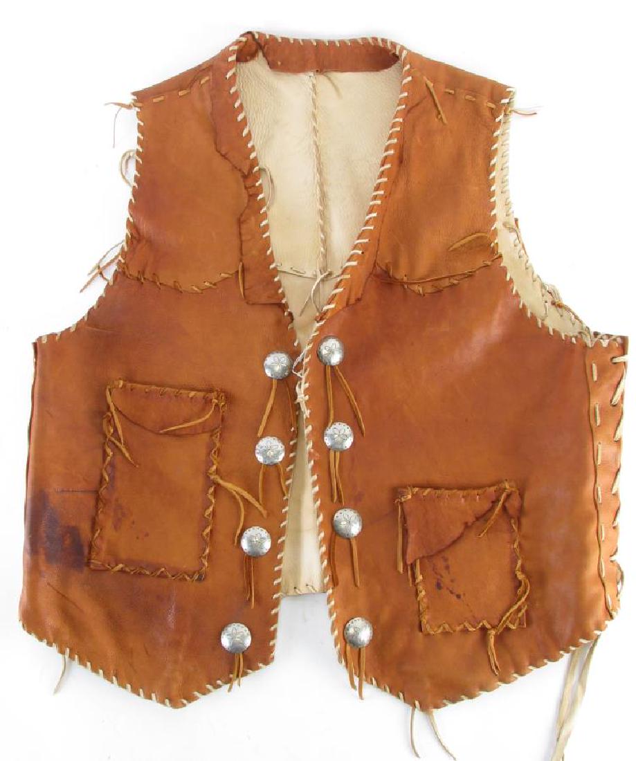 Montana Dreamwear Buckskin Cowboy Vest: Montana Dreamwear Buckskin Cowboy Vest, brown vest with two front pockets, eight floral and star decorated nickel buttons, two interior pockets, leather fringe accents, 24" collar to bottom and 24" ac