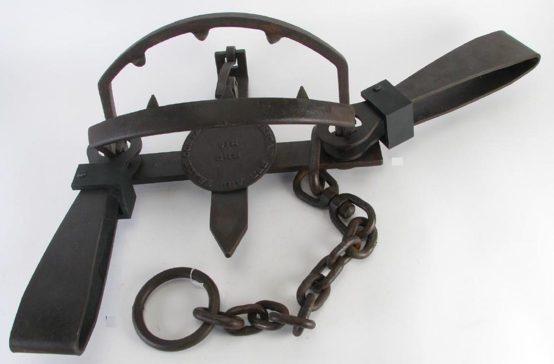 American Fur and Trade Company Bear Trap: American Fur and Trade Company Bear Trap, pressure plate marked "HBC, No. 6", trap features a double spring composition with a heavy gauge drag chain, ring and cast teeth on the jaws, dated "1922", 18