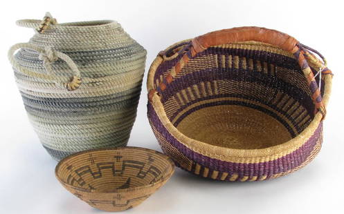 Handmade Baskets and Bowl: Handmade Baskets and Bowl, three total including: tan and grey waxed lasso basket; Native American woven basket with purple stripe decoration and leather wrapped handle; Native American tan woven bowl