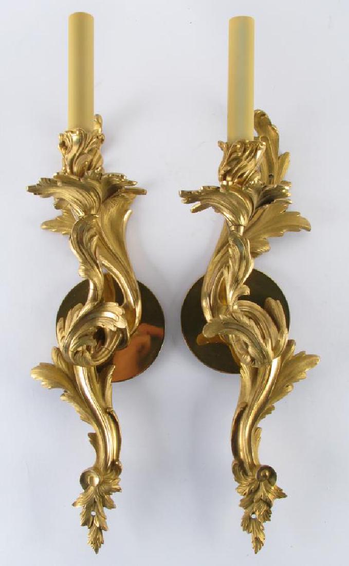 Pair of Louis XV Style Bronze Wall Sconces: Pair of Louis XV Style Bronze Wall Sconces, single light sconces with floral motif, electrified, 18" long