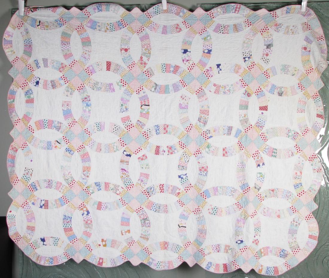 Vintage Handmade Pattern Quilt: A vintage handmade pattern quilt, double wedding ring, shows some wear, 85" x 69"
