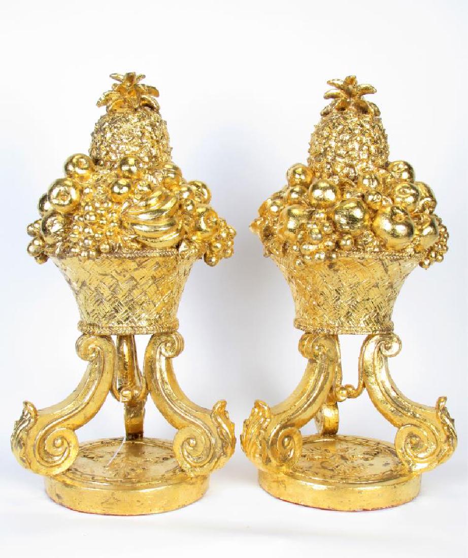 Pair of Gold Gilt Fruit Basket Floor Decorations: Pair of hand-gilt fruit basket floor decorations depicting basket with fruit, predominately pineapple, on a round, floral decorated base, 24" high