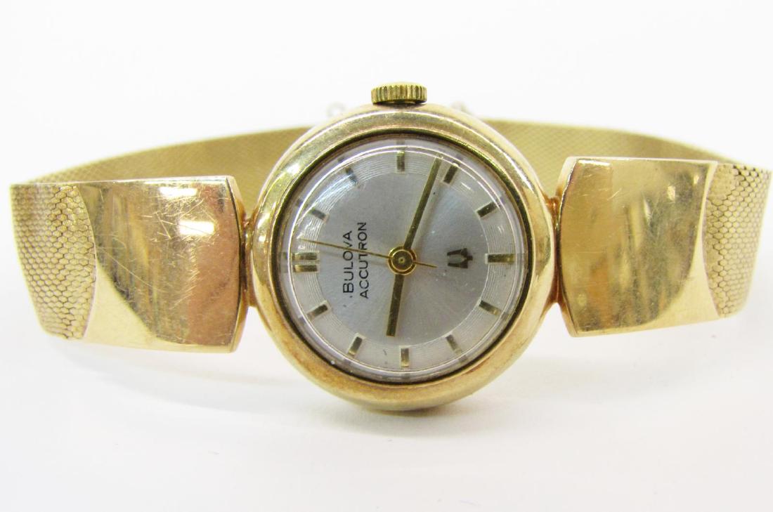Lady: A lady's 14K yellow gold Bulova Accutron wristwatch, case and mesh-style bracelet both marked 14k, quartz movement, round dial with stick markers