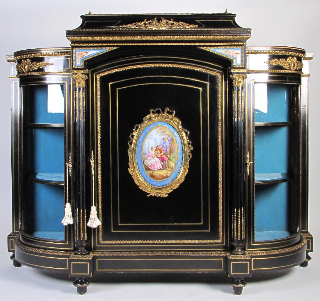 French Ebonized Cabinet de Curiosite: An ebony finish French Napoleon III style cabinet de curiosite, ca late 19th century, with Sevres porcelain medallions, brass gallery and mounted ormolu, blind door center opens to two interior shelve