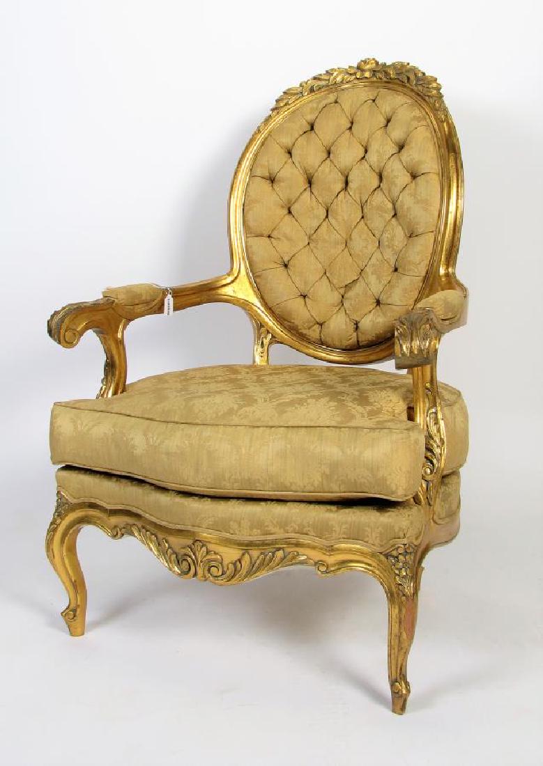 Carved French Bergere, Louis XV Style: A carved French Louis XV style bergere, gold leaf, floral and leaf carvings, damask upholstery, loose cushion seat, ca late 19th/early 20th cent, 45"h (one arm shows wear)