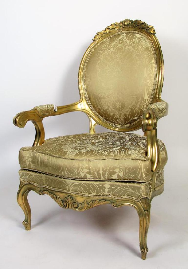 Carved French Bergere, Louis XV Style: A carved and gesso French Louis XV style bergere, leaf, flower and quatrefoil design, silk upholstery, loose cushion seat, ca late 19th/early 20th cent, 45"h