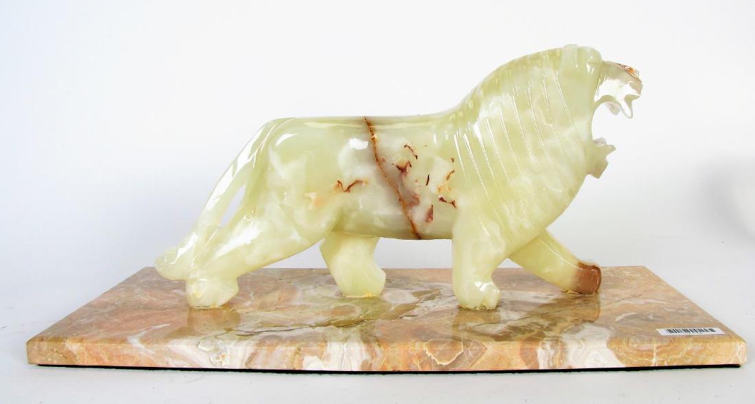 Onyx Carved Lion on Marble Base: Onyx Carved Lion on Marble Base, depicting a standing lion with roaring pose, carved from a single piece of alabaster, on rectangular marble base with beveled edges, 19" x 8" x 8.5" high