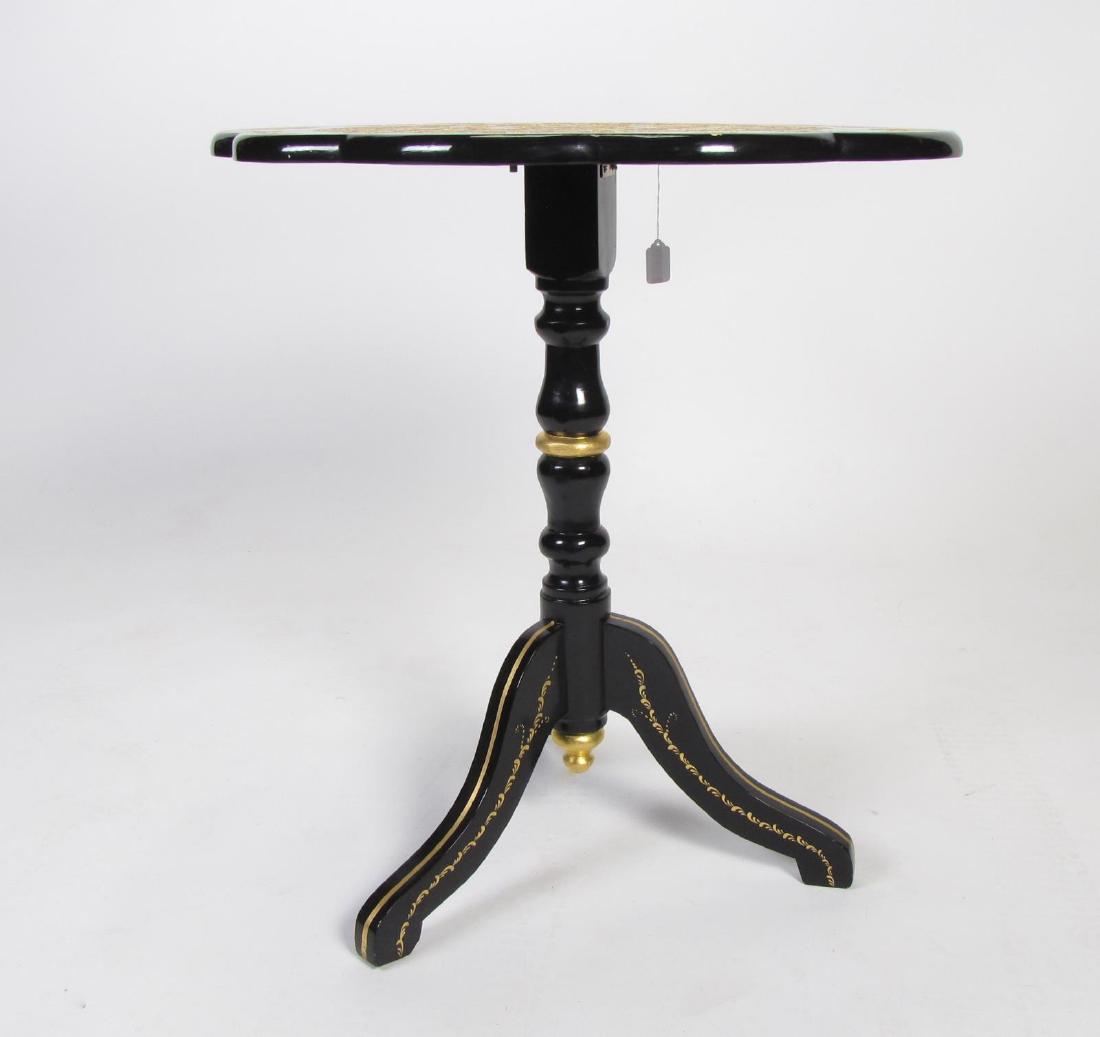 Black Lacquer Side Table, Tilt-top: A black lacquer, tilt-top side table, with scalloped edge, and having hand-painted enamel decoration on top, gold leaf accents on tripod base, 24 x 20 x 26"h