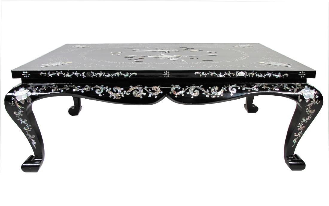 Inlaid Black Lacquer Cocktail Table: A black-lacquered Oriental style cocktail table, with inlaid mother-of-pearl and abalone inlaid decoration depicting doves and turtles, ca late 20th century, approx 50" x 37" x 18"h