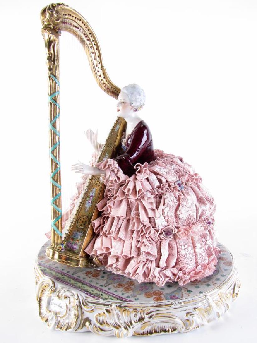 Italian Porcelain Figure "L'arpista": Italian Porcelain Figure "L'arpista", depicting a seated harpist in period dress, gold harp with hand painted floral decoration, oval porcelain base with gold accents and marked "L'arpista", signed on