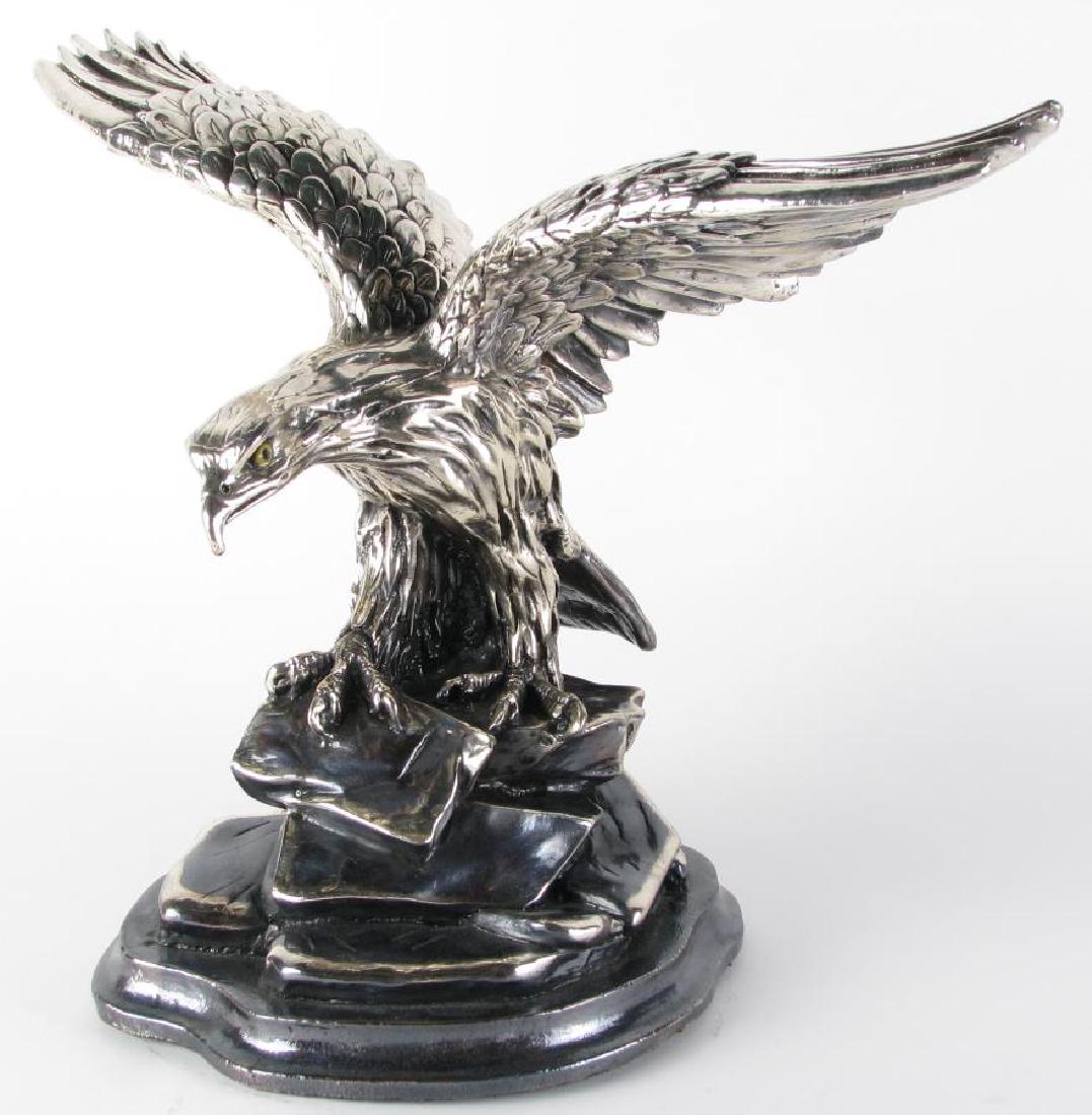 Plata Artistica Silver Clad Eagle Sculpture: Plata Artistica Silver Clad Eagle Sculpture, depicting an eagle with outstretched wings perched atop a rocky outcropping, hand painted yellow and black eyes, silver badge on underside reads "Plata Art