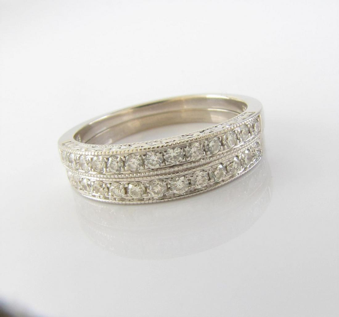 Pair of 14K White Gold Diamond Stack Rings: A pair of 14K white gold stack rings, each with thirteen burnish set round white diamonds, milgrain edges and engraved top and bottom, size 7.75 (1.6dwt) and size 7.5 (1.5dwt)