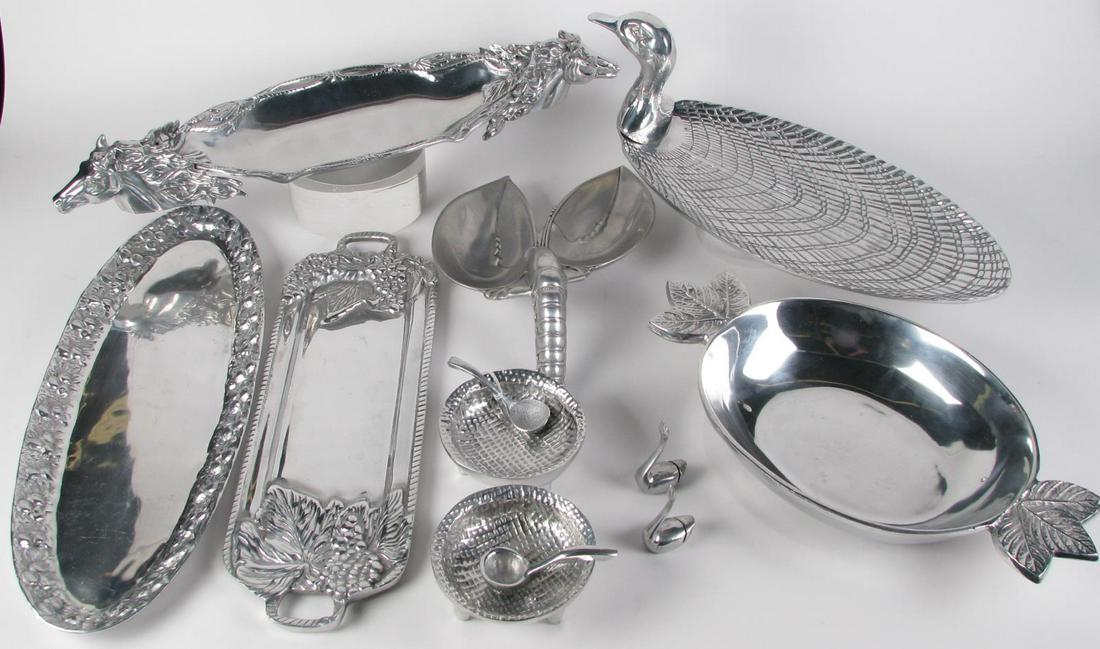 Cast Aluminum Tableware: Cast Aluminum tableware, ten items including oval bowl with floral handles; a pair of footed bowls with matching spoons; a narrow tray with grape and leaf decoration; oval tray with leaf and berry dec