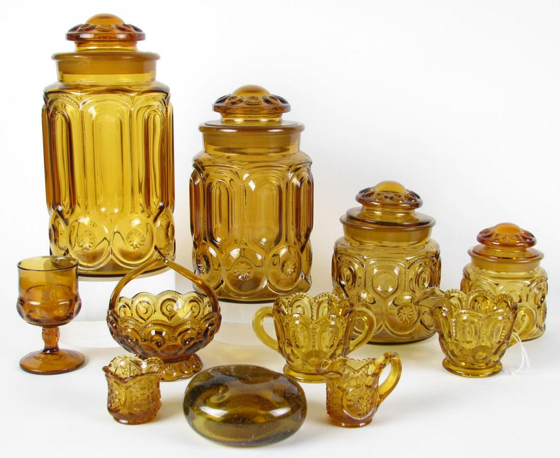 Twenty-One Amber Pattern Glass Items: Twenty-one Amber glass items including three extra large jars, four large jars, two medium jars, two small jars, all lidded; also includes three handled sugars, two creamers, a basket, a wine glass, a