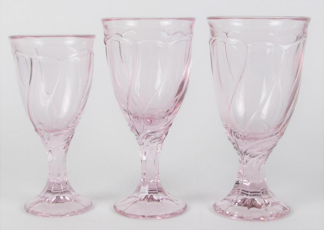 Decorated Stemware: Seventy-two decorated stemware items including (24) wine glasses, (24) iced tea and (24) wine goblets, pink stemware with swirl decoration