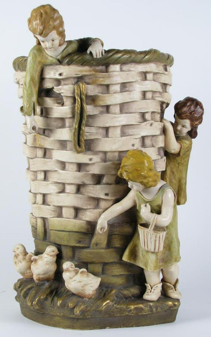 Porcelain Figural Floor Vase: A porcelain figural floor vase depicting large basket with children and chicks, 22.5" high