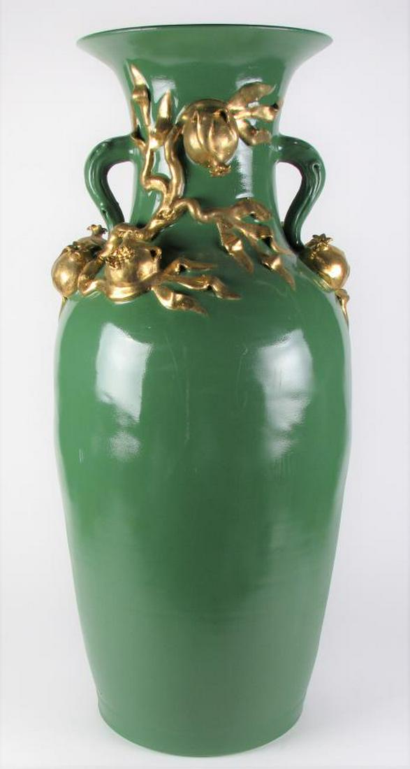 Monumental Pottery Floor Vase: A monumental pottery floor vase, green painted, double handle, with raided gold decorated pomegranates, 36.5" high