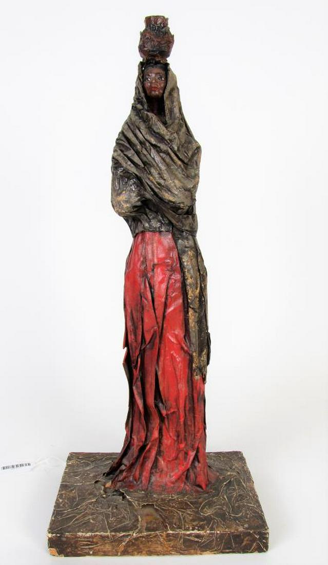 Papier Mache Otomi Sculpture: A papier mache Otomi sculpture, "India Otomi", depicting standing female figure carrying basket on head, tag on underside (translated from Spanish), For Berniece & Howard Hicks, Made in Mexico D.F., a