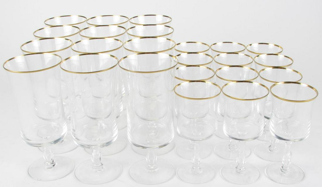 Two Sets of Gold Rim Crystal Stemware: Two sets of gold rim crystal stemware, twenty-four total including twelve wine glasses and twelve iced tea glasses, all with faceted stems, 5.5" and 7.5" high