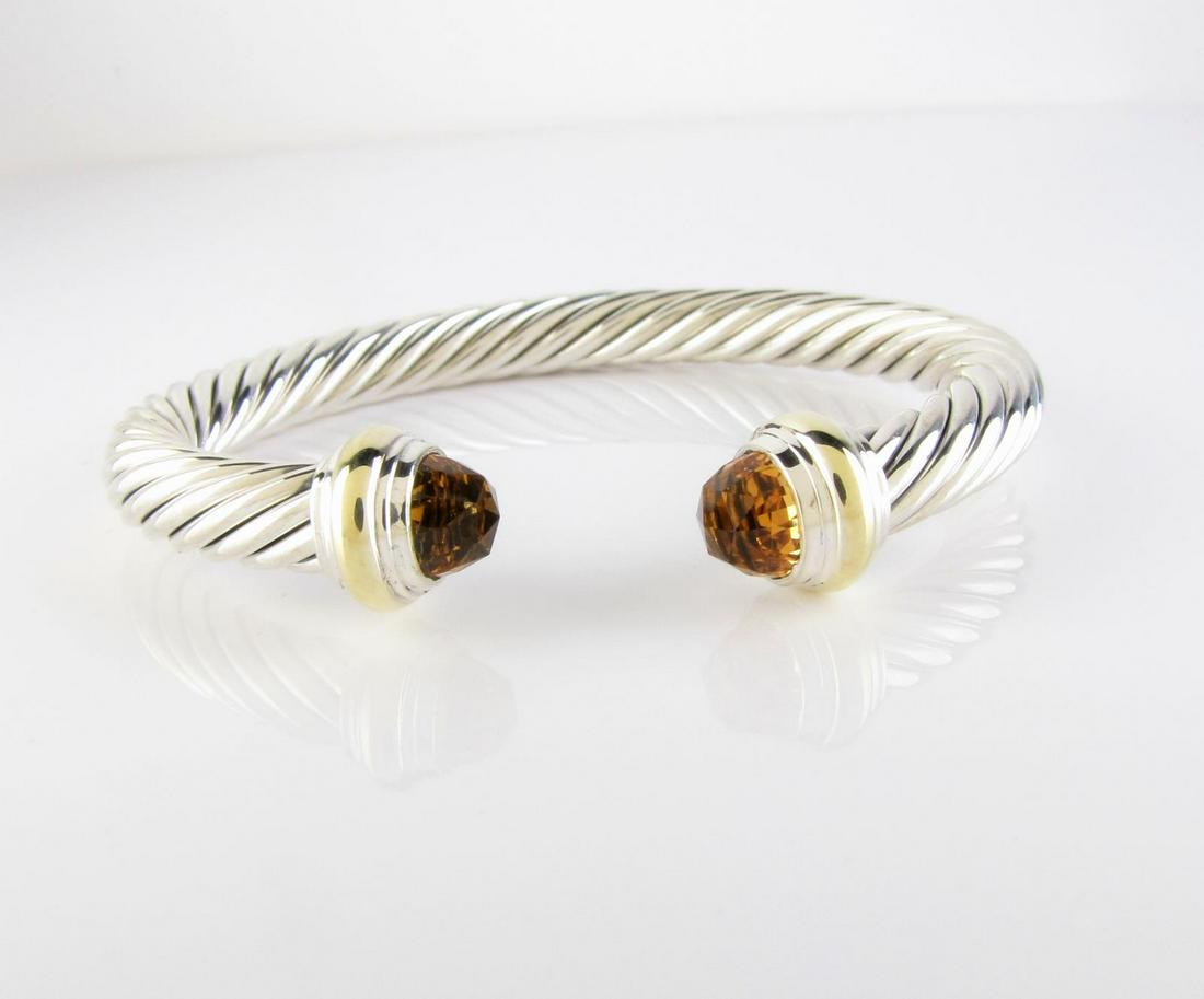 David Yurman 14K, Sterling Cable Cuff with Citrine: A David Yurman 14K yellow gold and sterling silver 7mm cable cuff bracelet with faceted citrine end stones