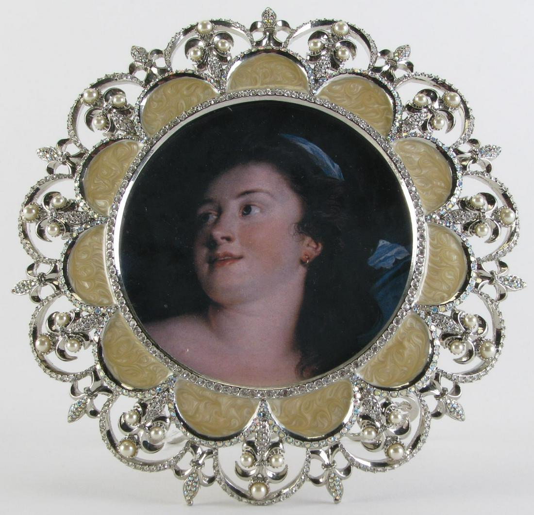 Jay Strongwater Picture Frame: A Jay Strongwater picture frame, round frame with cream enamel matting and pearl and Swarovski crystal decoration, signed Jay Strongwater on back, holds a 4" round photo, 6.75" x 7" high