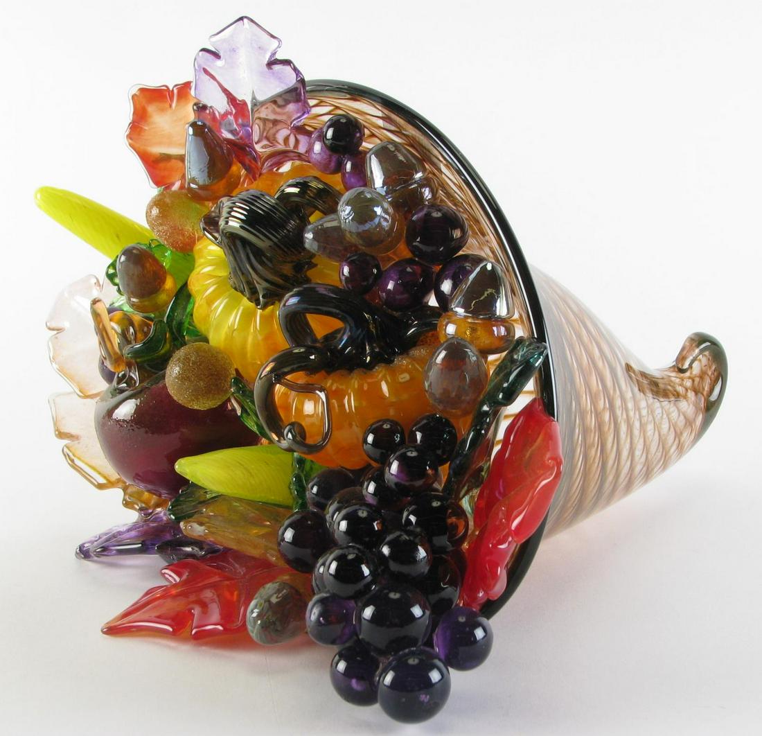 Art Glass Cornucopia Centerpiece: hand blown cornucopia with brown and green lattice decoration, filled with grapes, squash, acorns and peppers, autumn leaves line the bottom, 15" x 15" x 10" high