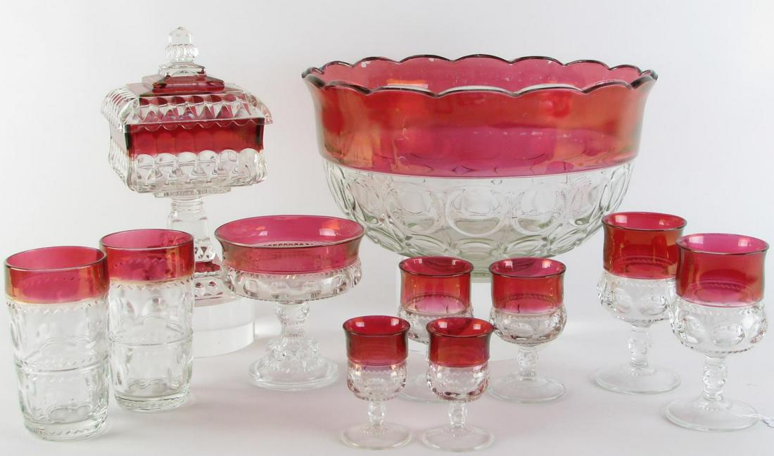 Ruby and Clear Pattern Glass: Fifty-five pieces of ruby and clear pattern glass including (17) wine glasses; (17) dessert wine glasses; (8) cordials; (1) punch bowl; (3) compotes; (1) lidded compote; and (8) tumblers