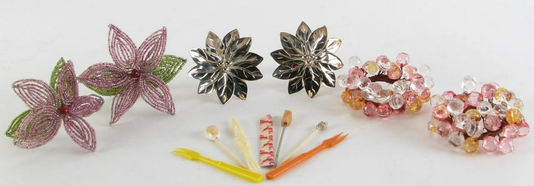 Three Sets Napkin Rings and Picks and Forks: Table setting accessories including three sets of napkin rings: Twenty-five metal floral formed, Eight plastic beaded, fourteen beaded floral; selling with an assortment shell decorated hors d'oeuvres