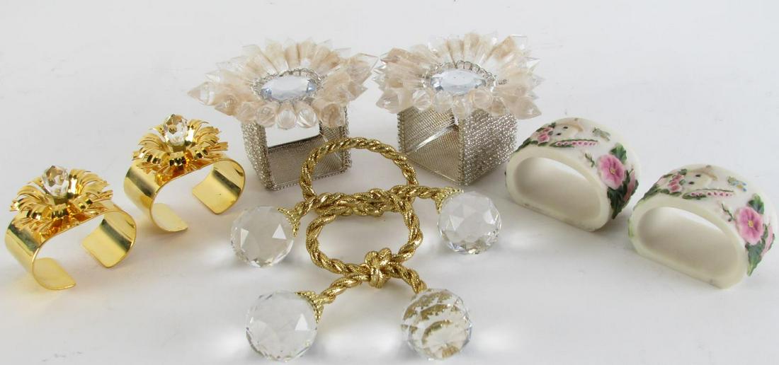 Large Group of Napkin Rings: Several sets of napkin rings including twenty gold cord and plastic prism tieback design; a set of twelve composite with cottage and floral decoration; eighteen brass-toned floral decorated; and fifte