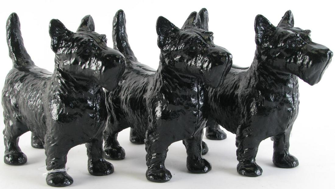 Three Black Cast Iron Scottie Dog Doorstops: Three black cast iron Scottie dog doorstops, each 8.5" high