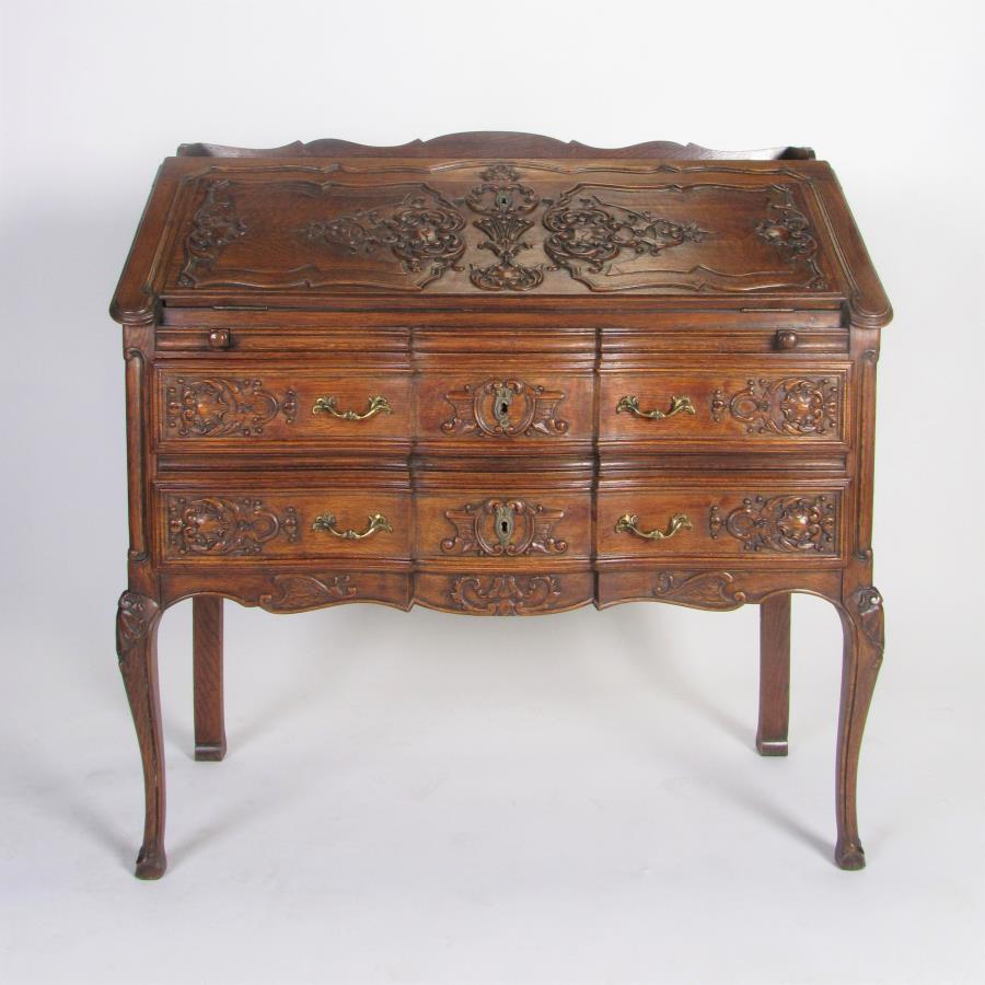 Antique French Secretary Desk: A French desk-secretary, with slant front revealing fitted interior, carved accents on front, oak, ca early 20th century, 38 x 16 x 38"h