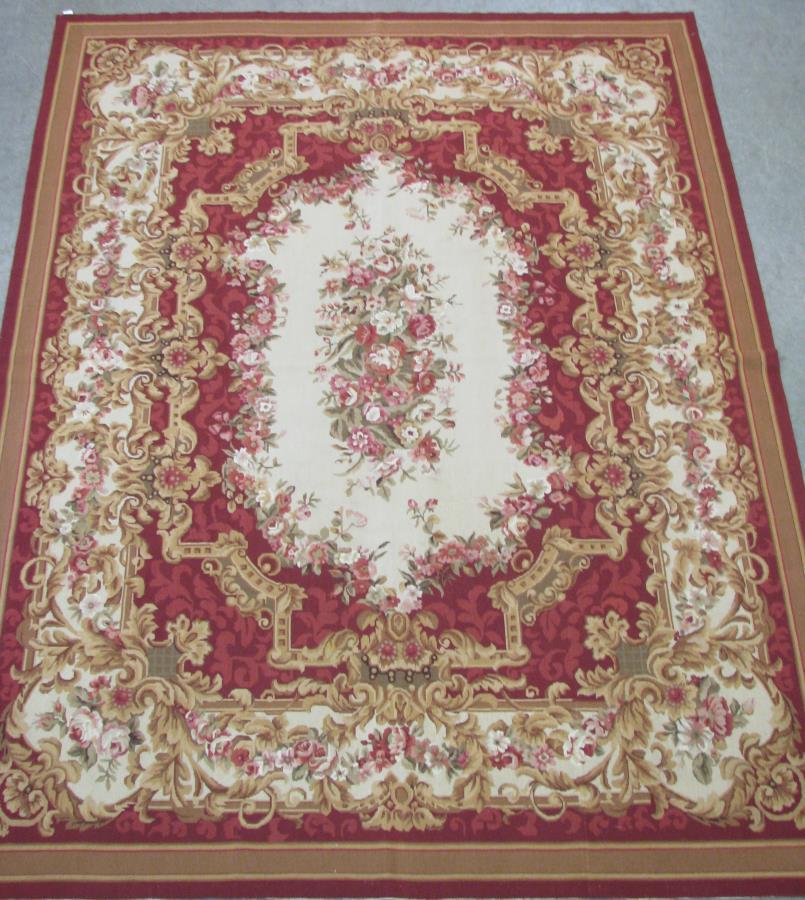 Hand Made Aubusson Needlepoint Room Size Rug: Hand Made Aubusson Needlepoint Room Size Rug, having a red field with cream floral decorated center medallion, red, tan and green floral decorated field, tan border with red and brown stripe decoratio