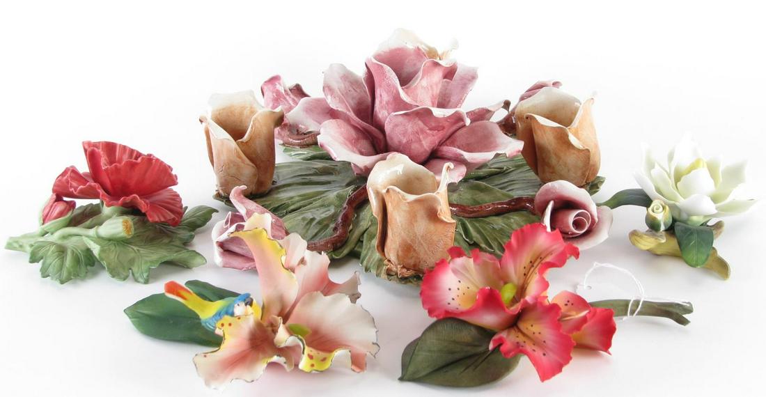 Five Porcelain Flower Groupings: Five porcelain flower groupings including two Capodimonte; an Andrea by Sedek white flower; a Lenox red puppy; a rose grouping made in Italy; 2.5" - 4.25" high