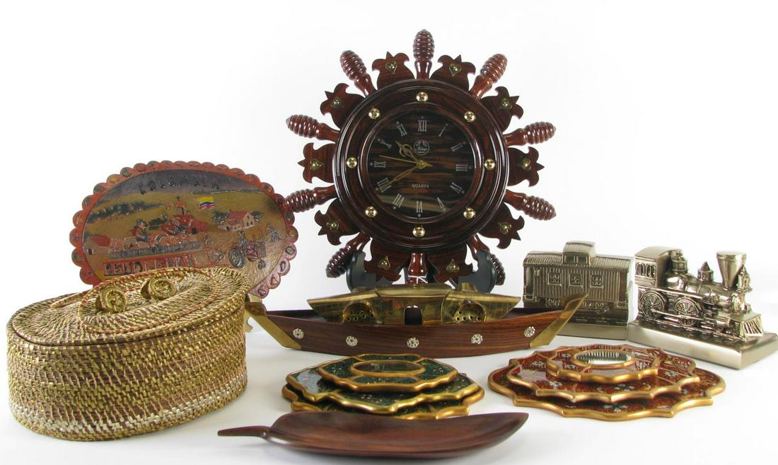 Thirteen Assorted Decorative Accessories: Thirteen Assorted Decorative Accessories, including: wooden ships wheel clock; wood carved leaf spoon rest; wood and brass boat; woven basket; cast metal train and caboose; leather mat depicting scene